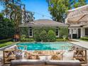 Relaxing pool with lounge area, surrounded by lush greenery, perfect for outdoor entertaining at 1400 Place Picardy, Winter Park, FL 32789
