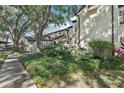 Exterior view of a well-maintained townhome with lush landscaping and mature trees offering ample shade at 1578 Farrindon Cir # 1578, Lake Mary, FL 32746
