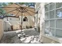 Secluded backyard patio area with brick pavers and a sunshade for a comfortable outdoor experience at 1578 Farrindon Cir # 1578, Lake Mary, FL 32746