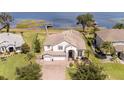 Lakefront two-story home with well-kept landscaping and a private dock for enjoying the water at 16054 Johns Lake Overlook Dr, Winter Garden, FL 34787