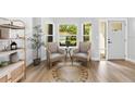 Bright sitting area with neutral furniture, large windows, and light wood floors at 1667 Spring Loop Way, Winter Garden, FL 34787