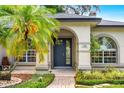 Close-up of the elegant front door and surrounding landscaping at 169 Winding Oaks Ln, Oviedo, FL 32765