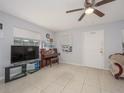 Bright living room with tile flooring, ceiling fan, and natural light from the window at 1708 Nebraska Ave, Kissimmee, FL 34744