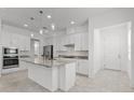 Modern kitchen featuring granite countertops, white cabinetry, and stainless steel appliances at 1855 Flora Pass Pl, Kissimmee, FL 34747