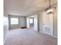 Bright, carpeted living room with lots of sunlight, neutral color scheme, and simple, elegant light fixture at 2426 Branch Way # 200, Maitland, FL 32751