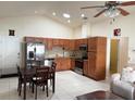 Open kitchen featuring stainless steel appliances and light brown cabinetry at 2612 Shantiniketan Blvd # G12, Tavares, FL 32778
