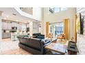 Open-concept living space with modern furnishings, kitchen view, and sliding glass doors leading to outdoor area at 2791 Punctuation Pl, Kissimmee, FL 34746