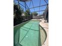 Large screened-in swimming pool surrounded by a spacious deck and privacy fence at 2857 Woodruff Dr, Orlando, FL 32837