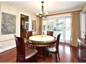 Dining room with a round table and chairs, hardwood floors, and sliding doors to the outdoor space at 2900 Cullen Lake Shore Dr, Belle Isle, FL 32812