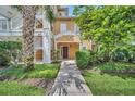 Charming home entrance with landscaped walkway, leading to a welcoming front door with detailed trim at 304 Rum Run # 304, Davenport, FL 33897