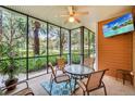 Inviting lanai features a ceiling fan, TV, and seating, perfect for relaxing and enjoying the outdoor scenery at 304 Rum Run # 304, Davenport, FL 33897