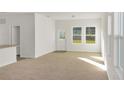Bright living room with new carpet, large windows, and natural light at 3053 Daffodil Dr, Lake Hamilton, FL 33851