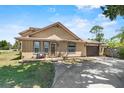 Inviting two-story home with a well-maintained lawn, driveway, and cozy front porch with seating at 3131 Juniper Dr, Edgewater, FL 32141