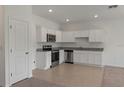 Stylish kitchen boasting white cabinetry, granite counters, and stainless steel appliances at 3394 Vesara Dr, Davenport, FL 33837