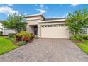 Beautiful home with a well-manicured lawn and landscaped front yard and a brick driveway at 3397 Sagebrush St, Harmony, FL 34773