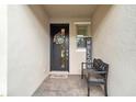Inviting front entrance with a bench, a welcoming wreath, and stylish brick pavers at 3397 Sagebrush St, Harmony, FL 34773