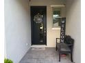 Inviting front door entrance with welcome decor and a comfortable bench at 3397 Sagebrush St, Harmony, FL 34773