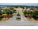 Aerial view of a gated community entrance with lush landscaping and well-maintained grounds at 344 Cadiz Loop, Davenport, FL 33837