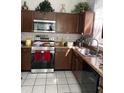 Well-equipped kitchen with stainless steel appliances, tile floors, and granite countertops at 3772 Huntwicke Blvd, Davenport, FL 33837