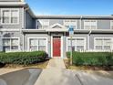 Inviting townhome with a vibrant red door and convenient handicap parking access at 4560 Spigold Court, Kissimmee, FL 34746