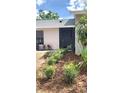 Well-maintained exterior with fresh landscaping and mulched flowerbeds at 5284 Indian Laurel Ct, Orlando, FL 32808