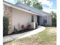 Charming home exterior with brick and stucco accents, complemented by lush landscaping and a well-manicured lawn at 5284 Indian Laurel Ct, Orlando, FL 32808
