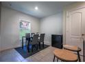 A simple dining room is brightened by a window and offers comfortable seating for a cozy meal at 543 Nardello Dr, Deltona, FL 32725