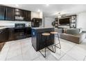 This updated kitchen offers black appliances, a center island with seating, and open access to the living room at 543 Nardello Dr, Deltona, FL 32725