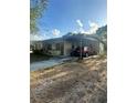 Single-story home featuring a carport, front yard, and neutral-toned exterior with a mix of sun and shade at 628 Cardinal St, Ocoee, FL 34761