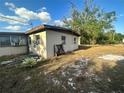 The back of a single story home with neutral siding and yard at 628 Cardinal St, Ocoee, FL 34761
