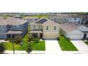 Two-story home in a residential area with solar panels, well-maintained lawns, and mature landscaping at 9040 Alba Ln, Kissimmee, FL 34747