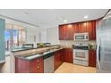 Cozy kitchen featuring dark wood cabinetry, stainless steel appliances, and granite countertops, perfect for cooking at 101 S Eola Dr # 812, Orlando, FL 32801