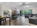 Bright and airy living room with dark wood floors, modern décor, and a sliding door to the outdoors at 111 Crown Oaks Way # 101, Longwood, FL 32779
