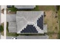 Drone shot of house rooftop featuring new solar panels and a well maintained asphalt shingle roof at 11456 Short Story St, Orlando, FL 32832