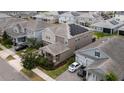 Aerial view of a neighborhood home showcasing solar panels, tidy landscaping, and a well-maintained exterior at 11456 Short Story St, Orlando, FL 32832