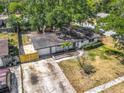 Aerial view of the house and the neighborhood with mature trees at 1298 Scottsdale Dr, Ormond Beach, FL 32174