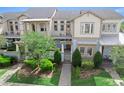 Attractive townhome with a well-maintained front yard, inviting walkway, and charming architectural details at 13865 Granger Ave, Orlando, FL 32827