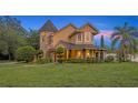 Charming home exterior featuring a covered porch, manicured landscaping, and unique architectural details at 1415 Brumley Rd, Chuluota, FL 32766