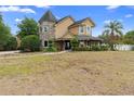A stunning two-story home featuring a turret and a well-manicured front lawn at 1415 Brumley Rd, Chuluota, FL 32766