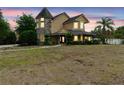 Charming two-story home with a stone tower, manicured lawn, and inviting front porch at 1415 Brumley Rd, Chuluota, FL 32766