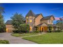 Stately exterior showcasing a unique turret design, lush landscaping, and inviting pathway to the front entrance at 1415 Brumley Rd, Chuluota, FL 32766