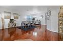 Elegant dining room with hardwood floors, modern decor, and a stylish gray dining set at 15210 Montesino Dr, Orlando, FL 32828