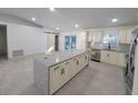 Bright, open kitchen featuring a large island, stainless steel appliances, and sliding doors at 16742 Se 165Th Ave, Weirsdale, FL 32195