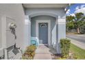 Inviting front entrance with covered porch and blue door at 2288 Leland Ln, Casselberry, FL 32707