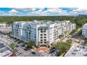 Wide angle aerial view of a modern condominium building with many windows, balconies, and green roof accents at 2305 Edgewater Dr # 1604, Orlando, FL 32804