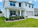 Beautiful two-story home featuring a cozy front porch and lush landscaping at 239 Se 66Th Ct, Ocala, FL 34472