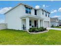 Inviting two-story home with a covered front porch and meticulously maintained yard at 239 Se 66Th Ct, Ocala, FL 34472