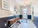 Inviting foyer with modern decor, tiled floors, and stylish wall accents at 303 Ocean Course Ave, Davenport, FL 33896