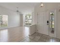 Bright and airy living room featuring tile entryway, laminate floors, ceiling fan, and natural light at 3780 Ventura Cove Dr, Orlando, FL 32822