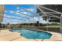 A screened-in pool area with views of lush landscaping and blue skies at 3780 Ventura Cove Dr, Orlando, FL 32822